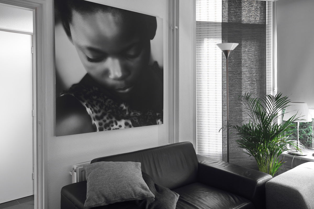 Vintage black and white portrait printed on Xpozer hanging above a sofa couch